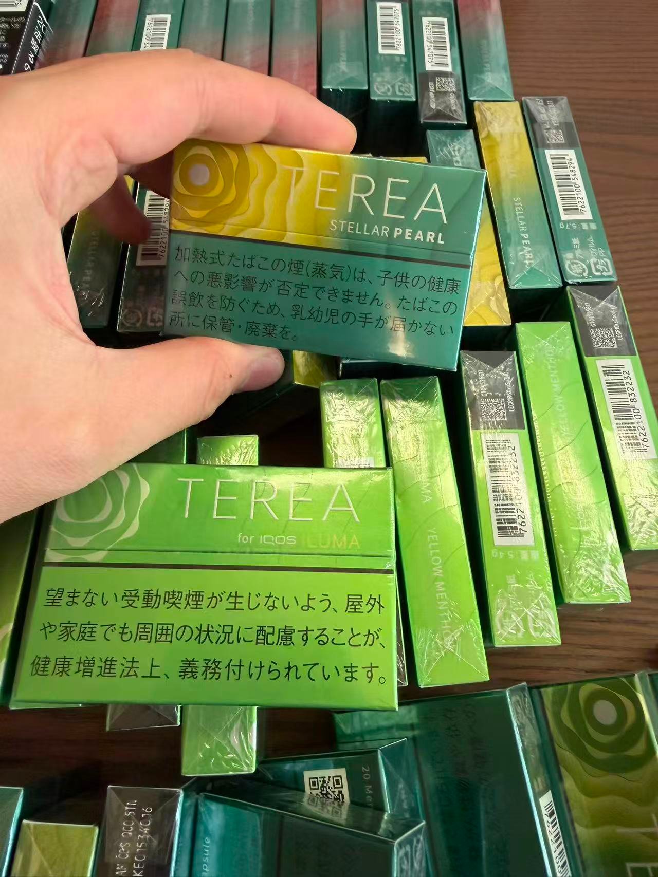 TEREA Stellar Pearl pack held over a display of TEREA products